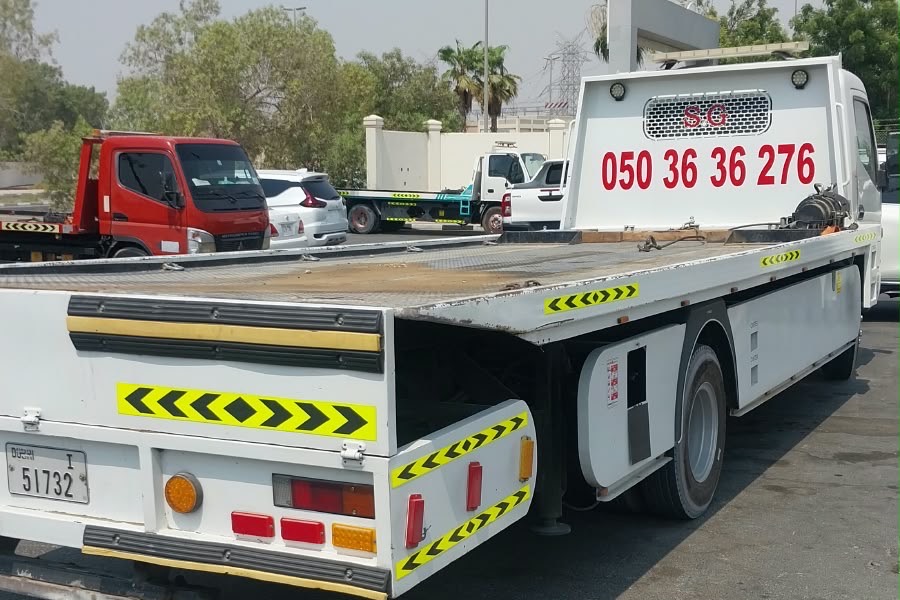 Tanveer Recovery flatbed tow truck in Ajman with 050 36 36 276 on the headboard